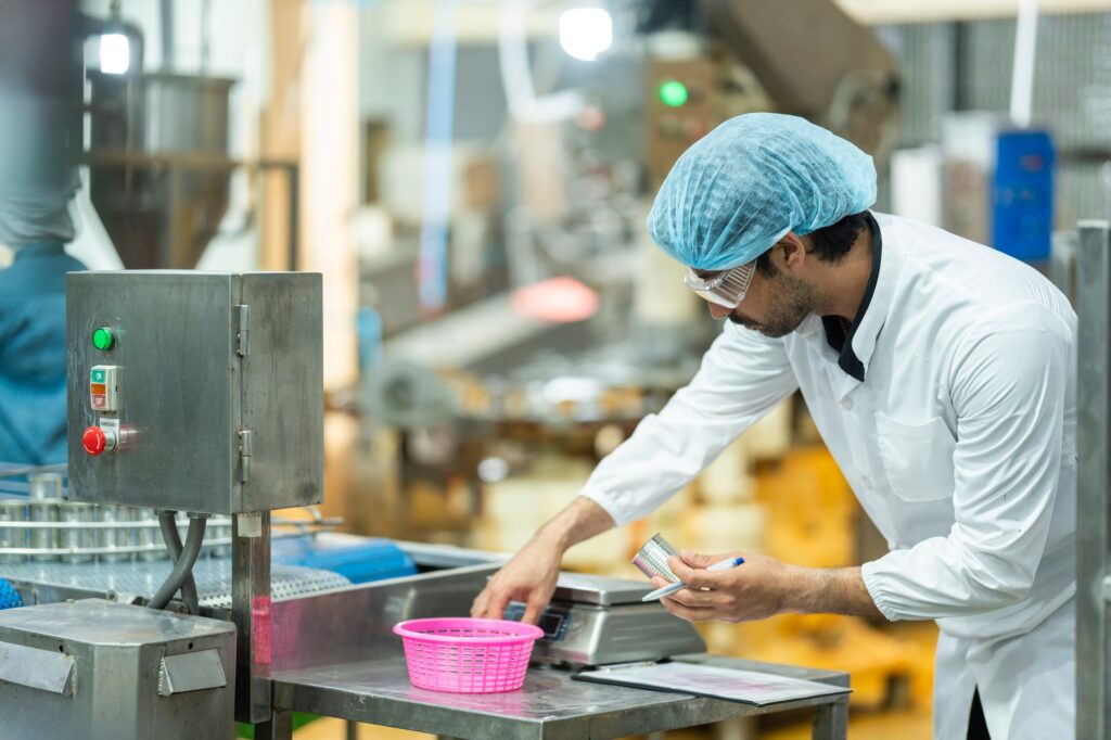Inspector checking automated machinery in food production